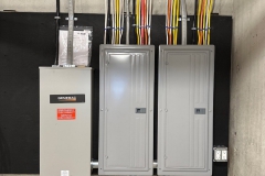 All Phase Electric LLC | Generac automatic transfer switch beside two new load centres in a basement | Southern NH