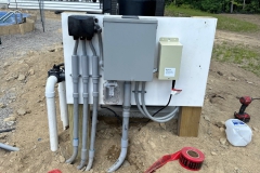 All Phase Electric LLC | Outdoor pool equipment disconnect and sub-panel on a weatherproof backboard | Southern NH
